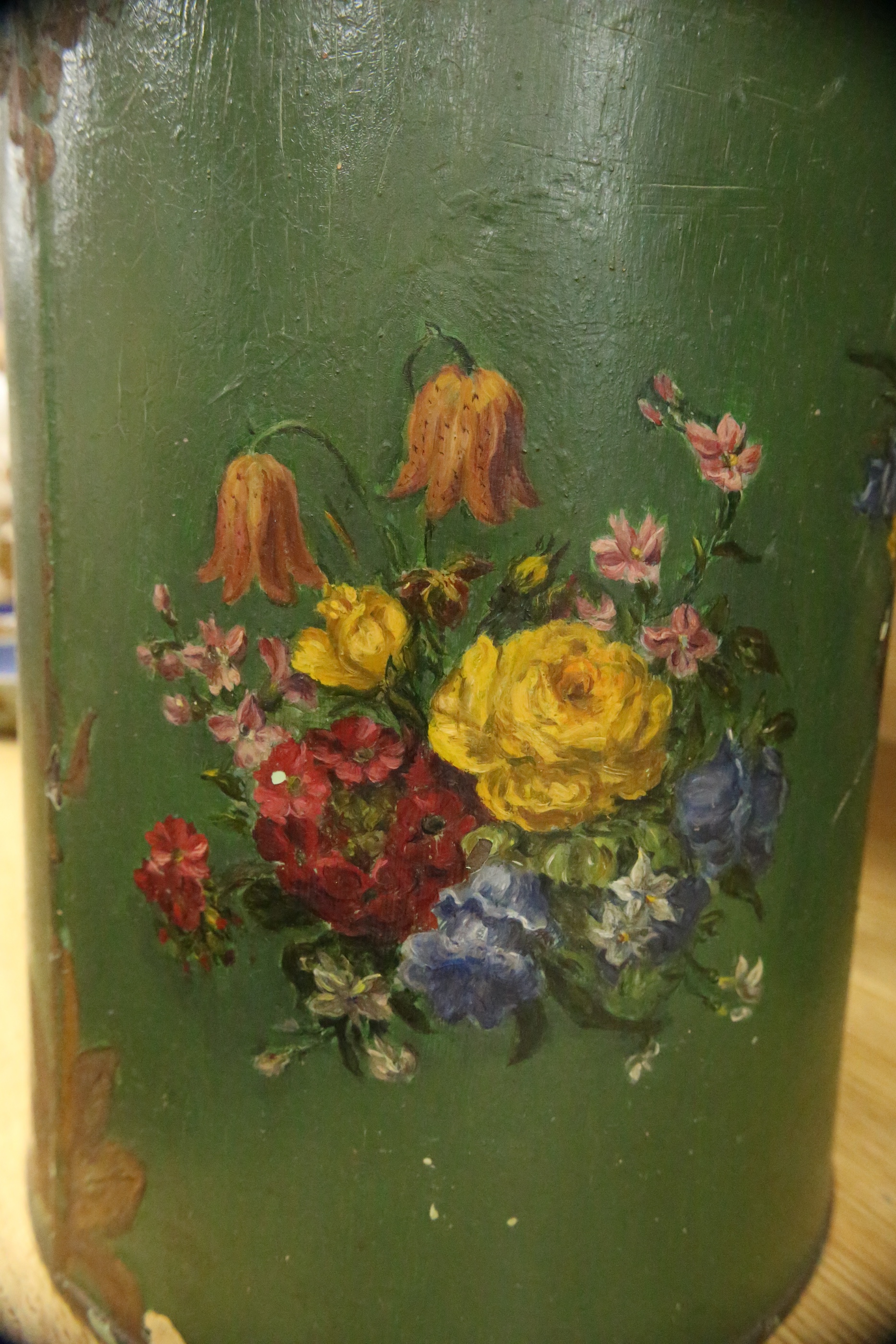 A green toleware floral decorated tea canister, 42cm high. Condition - poor, many chips to surface paint